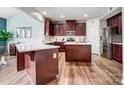 Spacious kitchen features granite countertops, dark wood cabinets, a kitchen island and modern stainless appliances at 2065 Taney Way, Fort Mill, SC 29707