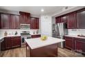 Modern kitchen with stainless steel appliances, a large island and dark wood cabinetry at 2065 Taney Way, Fort Mill, SC 29707