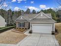 Charming single-story home with stone accents, well-maintained landscaping, and attached two-car garage at 23234 Kingfisher Dr, Indian Land, SC 29707