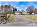 House exterior showcasing a driveway and front yard at 2363 24Th Street Ne Ln, Hickory, NC 28601