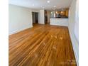 Open-concept living room flows into a kitchen with stainless steel appliances and warm wood cabinets at 238 Coxe Ave, Charlotte, NC 28208