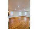 Sunny living room featuring wood floors, recessed lighting, and windows at 238 Coxe Ave, Charlotte, NC 28208