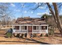 Brick ranch house with a front porch and landscaping at 2614 S Us 321 Hwy, Newton, NC 28658