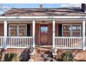 Inviting front porch with white railings and red door at 2614 S Us 321 Hwy, Newton, NC 28658