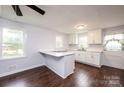 Renovated kitchen with white cabinets, island, and dark hardwood floors at 2752 21St Ne St, Hickory, NC 28601