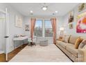 Bright bedroom with taupe sofa, pink accents and home office space at 305 Ideal Way, Charlotte, NC 28203