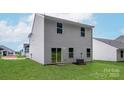 Rear view of the house showcasing a sliding glass door and backyard at 3258 Maple Ridge Dr, Gastonia, NC 28052