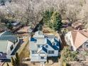 Aerial view of a home with a fenced backyard, nestled among mature trees and neighboring houses in a quiet neighborhood at 3724 Commonwealth Ave, Charlotte, NC 28205