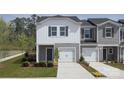 Two-story townhome with gray siding, white accents, and a two-car garage at 5054 Kellaher Pl, Charlotte, NC 28216