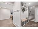 Stylish entryway with built-in bench, storage, and wood-look flooring at 5066 Summer Surprise Ln, Charlotte, NC 28215