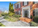 Brick front entrance with black door and columns, flanked by landscaping at 6328 County Donegal Ct, Charlotte, NC 28277