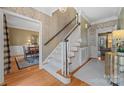 Elegant staircase with a white banister and carpeted steps at 6328 County Donegal Ct, Charlotte, NC 28277