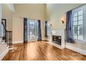 Spacious living room with hardwood floors, fireplace and large windows at 6926 Linkside Ct, Charlotte, NC 28277