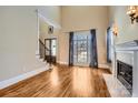 Bright living room with hardwood floors, fireplace and high ceilings at 6926 Linkside Ct, Charlotte, NC 28277