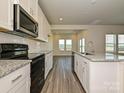 Modern kitchen with granite countertops and stainless steel appliances at 821 Blue Canyon Dr, York, SC 29745