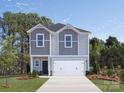 Two-story house with gray and white siding, white garage door, and landscaping at 841 Blue Canyon Dr, York, SC 29745