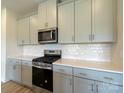 Modern kitchen with gray cabinets, white quartz countertops, and stainless steel appliances at 841 Blue Canyon Dr, York, SC 29745