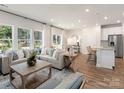 Spacious living room with a light gray sectional sofa, wooden coffee table, and hardwood floors at 841 Blue Canyon Dr, York, SC 29745