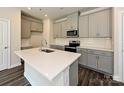 Kitchen boasts an island with white quartz countertops and gray cabinets at 853 Blue Canyon Dr, York, SC 29745