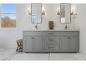 Double vanity bathroom with gray cabinets and marble countertops at 8788 Potter Rd, Matthews, NC 28104