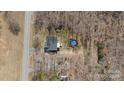 Overhead shot showcasing the home's layout, back deck, and above ground pool at 888 Brevard Place Rd, Iron Station, NC 28080