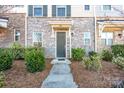 Townhome's front entrance with stonework, landscaping, and a walkway at 9115 Bluefield St, Charlotte, NC 28273