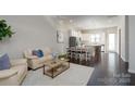 Open living room and kitchen with hardwood floors, neutral colors, and a light and airy feel at 9115 Bluefield St, Charlotte, NC 28273