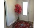 Welcoming foyer featuring a decorative tree and an eye-catching round rug near the front door at 106 Milliner Dr # 97, Troutman, NC 28166