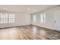 Bright living room with wood-look floors and natural light streaming through multiple windows at 1171 Blackburn Cir, Edgemoor, SC 29712