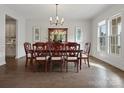 Elegant dining room with wood floors, large windows, and stylish chandelier at 120 Trelawn St, Fort Mill, SC 29715