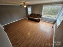 Living room with laminate wood floors and a brown couch at 13655 Broadway Ave, Midland, NC 28107