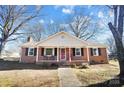 Charming brick ranch house with red door and inviting front porch at 2203 O'Hara Dr, Charlotte, NC 28273