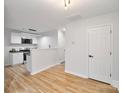 Modern eat-in kitchen with white cabinets and light wood floors at 311 Drury Dr, Charlotte, NC 28206