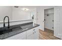 White shaker cabinets, dark countertops, and a modern farmhouse sink at 311 Drury Dr, Charlotte, NC 28206