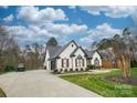 White brick house with brown accents and a long driveway at 31934 Ameron Cir, Albemarle, NC 28001