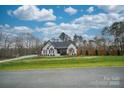 House with white brick and brown accents, large yard at 31934 Ameron Cir, Albemarle, NC 28001