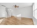 Open living room featuring hardwood floors, stairs with stylish design, and lots of natural light at 3220 Capitol Dr, Charlotte, NC 28208