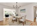 Cozy dining room featuring hardwood floors, modern light fixtures, and comfortable seating at 3828 Chandworth Rd, Charlotte, NC 28210