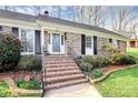 Charming brick home featuring manicured lawn and walkway to the front entrance at 3828 Chandworth Rd, Charlotte, NC 28210