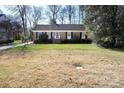 Traditional brick home featuring well-maintained front yard and mature trees at 3828 Chandworth Rd, Charlotte, NC 28210