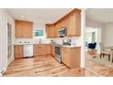 Bright kitchen features light wood cabinetry, stainless appliances, and a window view at 3828 Chandworth Rd, Charlotte, NC 28210