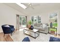 Inviting living room with vaulted ceilings, skylight, comfortable seating, and a view of the deck at 3828 Chandworth Rd, Charlotte, NC 28210