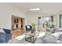 Inviting living room with a ceiling fan, a comfortable seating arrangement, and sliding doors to a deck at 3828 Chandworth Rd, Charlotte, NC 28210