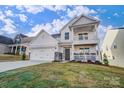 Two-story house with white siding, stone accents, and a balcony at 5036 Heathland Dr # 71, Charlotte, NC 28215