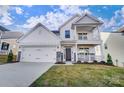 Two-story house with white siding, stone accents, and a front porch at 5036 Heathland Dr # 71, Charlotte, NC 28215