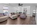 Living room featuring L-shaped sectional and wood floors at 505 Viking Sw Dr, Concord, NC 28025