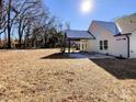 Large backyard with a covered patio and mature trees at 604 N Providence St, Waxhaw, NC 28173