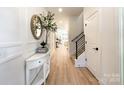 Bright entryway with hardwood floors, white walls, and a half-wall at 604 N Providence St, Waxhaw, NC 28173