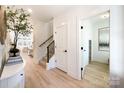 Bright entryway with hardwood floors, white walls, and a staircase at 604 N Providence St, Waxhaw, NC 28173