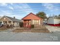 Charming brick home featuring a cozy front porch and well-maintained landscaping at 630 N Moran St, Gastonia, NC 28052